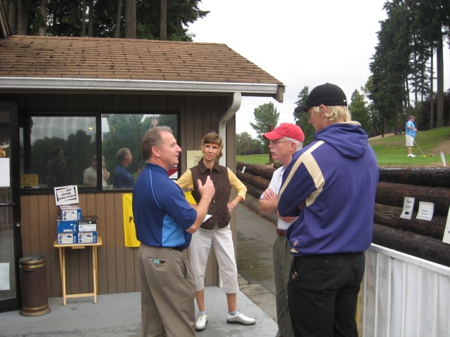 Marty Blanchard on left, at the start of our round of golf, giving us instructions. Most of us were not paying attention. Rondi Edwardson and Jim Steinruck and son...